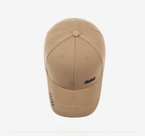 Top-down view of khaki baseball cap with navy AHWT embroidery and side text detail