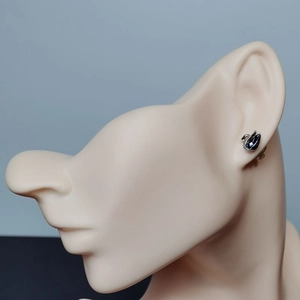 Elegant swan earrings featuring blue heart crystals on a realistic female mannequin