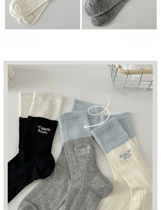 Detail of ribbed mid-calf socks with Bebe Bonjour embroidery and contrast color cuffs