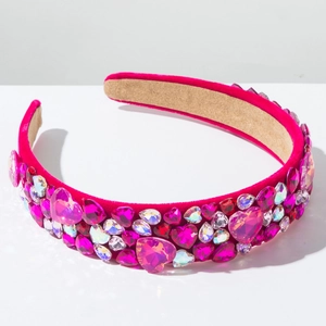 Close-up of pink velvet headband with vibrant rhinestones and colorful heart crystals