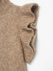 Detail shot of tan knit top showing thick ruffle accents and textured wool blend fabric