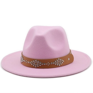 Detail of pink wool fedora hat featuring a brown leather band with silver metal studs