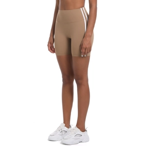 Detail of khaki high-waisted yoga shorts with white side stripes on athletic fit model