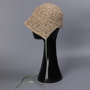 Detail of handwoven straw hat with light green ribbon tie on a display model