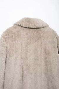 Detail of light beige faux fur coat collar and texture with thick warm material