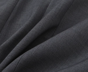 Detailed close-up of dark grey twill fabric texture and draped material for V-neck dress