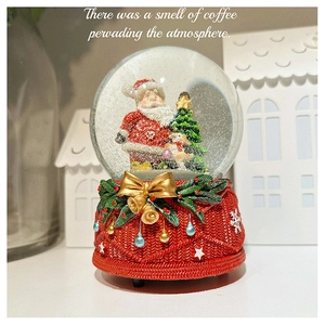 Detail of Christmas snow globe with knitted texture red base and Santa Claus figurine