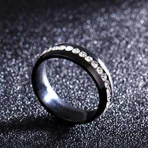 Macro shot of a 6mm black stainless steel ring featuring a row of sparkling crystal rhinestones