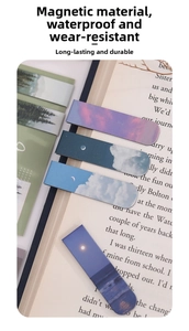 Waterproof magnetic bookmarks featuring aesthetic cloud and sunset landscapes in a book