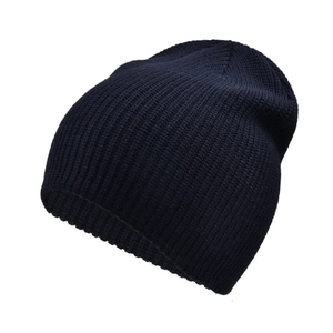 Detailed view of navy blue knitted beanie showing thick ribbed texture and warm fabric