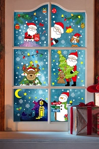 Detail of Christmas window clings featuring Santa and reindeer on a winter glass pane