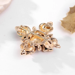 Baroque style golden cross brooch with pearl back view showing secure pin clasp mechanism