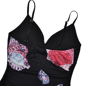 Close-up detail of adjustable straps and shell print texture on a black slim dress