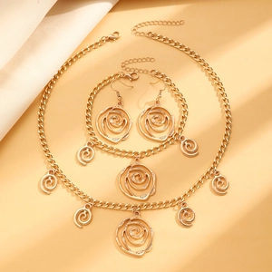 Three-piece golden metal jewelry set featuring hollow rose flower swirl designs