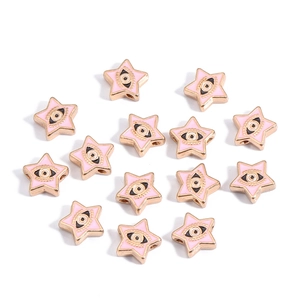 Macro detail of pink star-shaped evil eye beads with golden edges and enamel finish