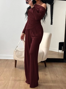 Elegant two-piece burgundy set featuring long sleeve off-shoulder top and wide-leg trousers