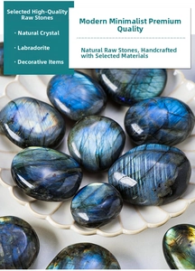 Close-up of polished labradorite stones with blue flash in a white ceramic dish