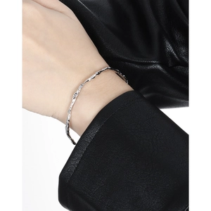 Minimalist S925 sterling silver open bangle with molten lava texture on female model
