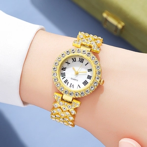 Detailed view of luxury gold watch with sparkling rhinestones and Roman numeral dial