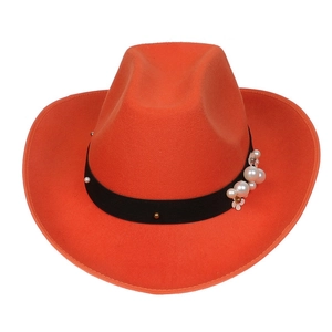 Detail of orange wool cowboy hat with black ribbon, white pearls and gold stud accents