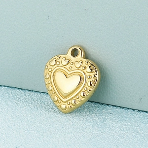 Close-up of golden heart pendant with embossed heart patterns and hanging ring loop