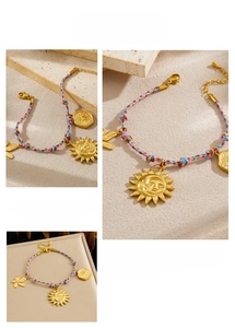 Bohemian braided cord bracelet with sun and moon gold pendants on a natural stone base