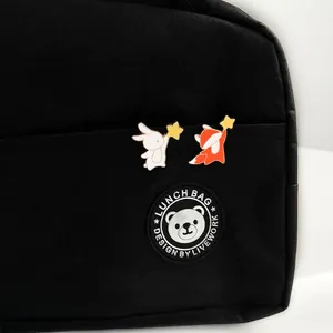 Cute enamel animal brooches featuring a white bunny and orange fox holding bright yellow stars