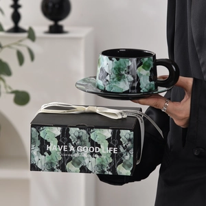 Ceramic coffee cup and saucer gift set with floral pattern in a decorative gift box