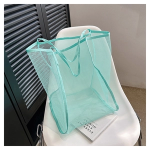 Detail shot of the breathable mesh texture on this mint green tote bag with dual handles
