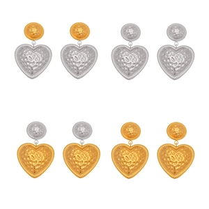 Fashionable heart-shaped stud earrings with hammered metal texture in gold and silver