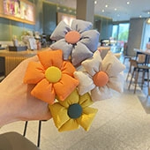 Close-up of colorful flower hair clips for girls featuring soft fabric textures