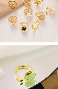 Close-up of adjustable gold-plated ring with a green rabbit motif on a mirror surface