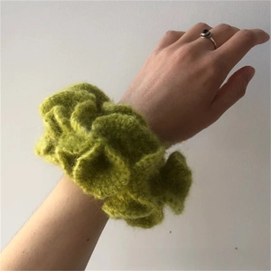 Detailed texture of a handmade lime green crochet ruffle hair scrunchie accessory