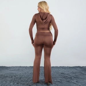 Back view of brown two-piece tracksuit with hooded zip top and flared pants in silky fabric