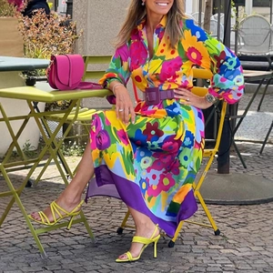 Close-up of floral print long sleeve shirt dress with a wide purple waist belt