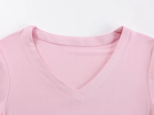 Close-up of the V-neckline and fine knitted texture on this pink summer T-shirt