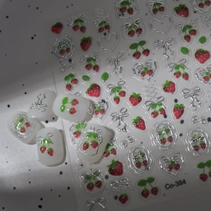 Macro detail of 3D embossed strawberry and silver bow nail art stickers model Co-384