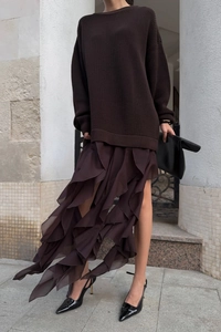 Detail of dark brown knit sweater paired with multi-layer ruffled chiffon skirt