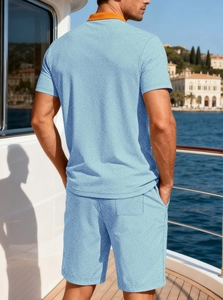 Detail of light blue knit texture and orange contrast collar on men's summer vacation set
