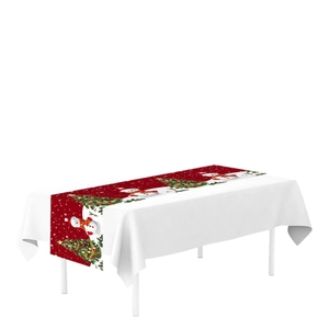 Festive Christmas table runner with snowman and tree patterns on a red background