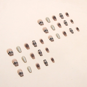 Black and white checkerboard press-on nails with glitter accents and gradient finish
