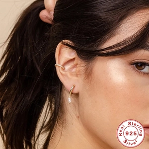 S925 sterling silver gold earrings with pearl pendants and cubic zirconia on model
