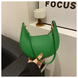 Detail of green PU leather crescent shoulder bag featuring smooth texture and metal zipper