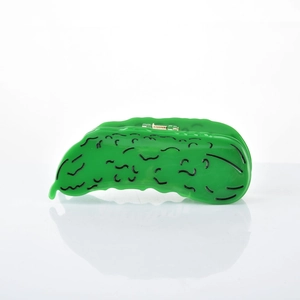 Detailed view of creative green cucumber shaped acetate hair claw clip with golden spring