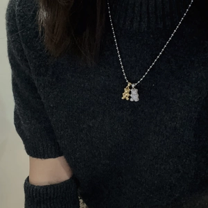 Titanium steel necklace featuring polished gold bear and micro-pave zircon silver bear pendants