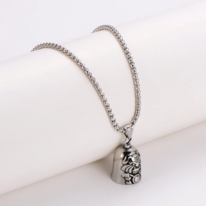Vintage silver dog bell pendant necklace with embossed patterns on a woven chain