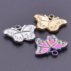Detailed view of butterfly charms in gold, silver, and rainbow stainless steel finishes