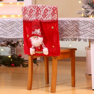 Detail of red velvet Christmas chair cover with 3D Santa gnome and gold star accents