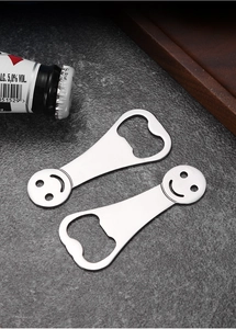 Flat stainless steel beer bottle openers with smiley face design on dark stone texture