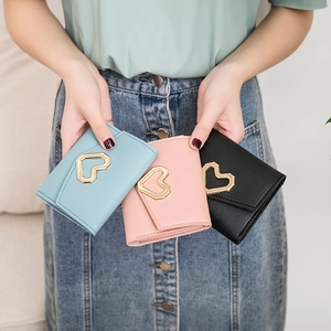 Three elegant heart-shaped buckle purses in blue, pink, and black PU leather